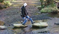 Finn jumping rocks.